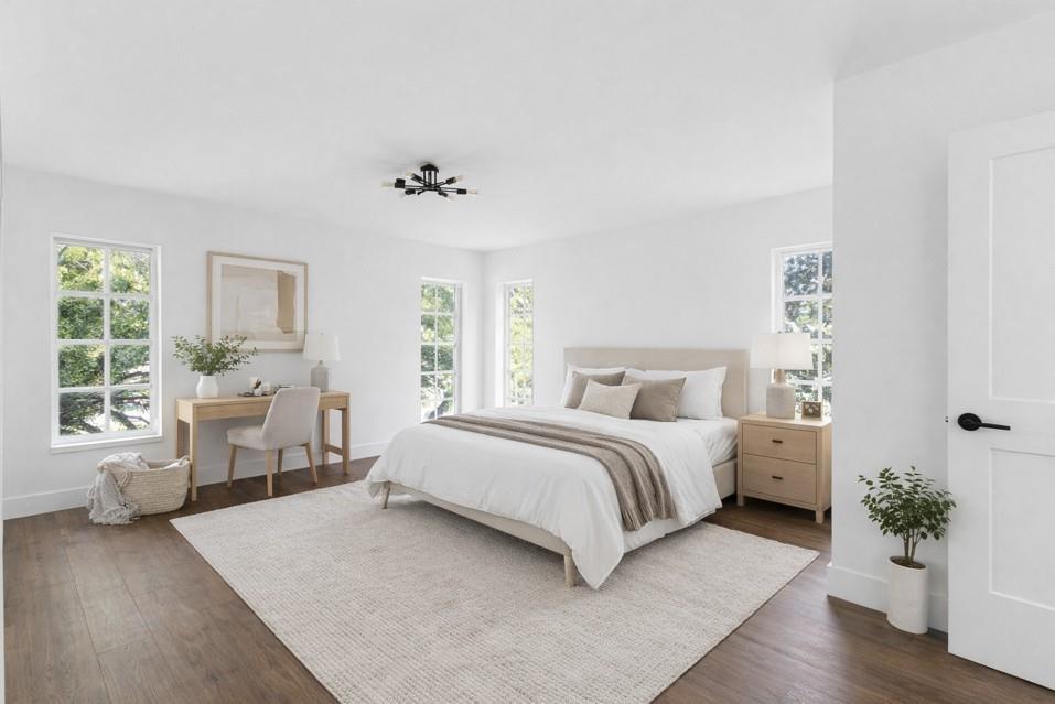 A bright bedroom features white walls, wood flooring, a bed, a desk, and multiple windows — 2800 N Palm Aire Drive # 310, Pompano Beach FL 33069, POMPANO BEACH, FL