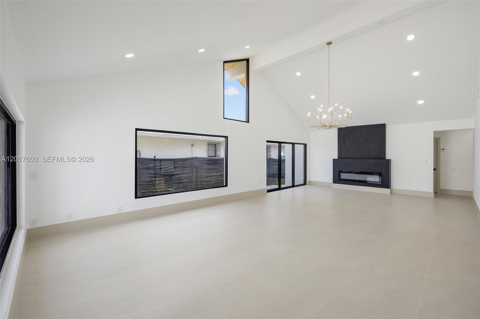 A modern house with a slanted roof and a dark garage door faces a driveway — 2851 SW 117th Ave, Miami FL 33175, MIAMI, FL