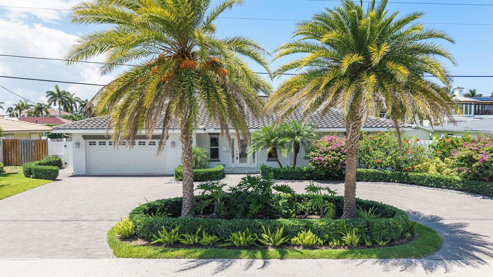 A single-story house with a paved driveway, two large palm trees, and landscaped garden beds — 831 Dover Street, Boca Raton FL 33487, BOCA RATON, FL