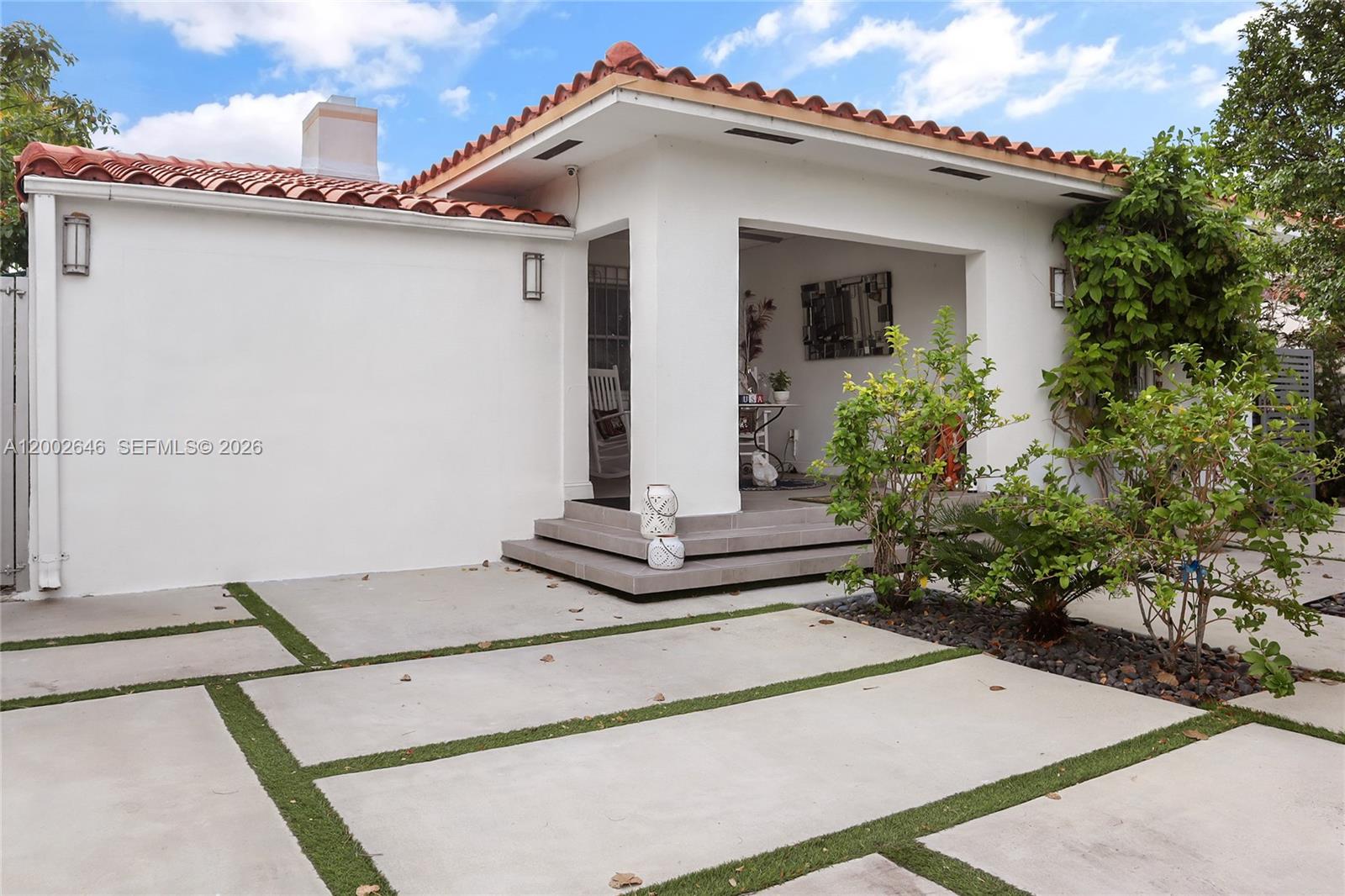 A white house with a red tile roof features a covered porch and concrete pavers — 619 SW 39th Ave, Miami FL 33134, MIAMI, FL