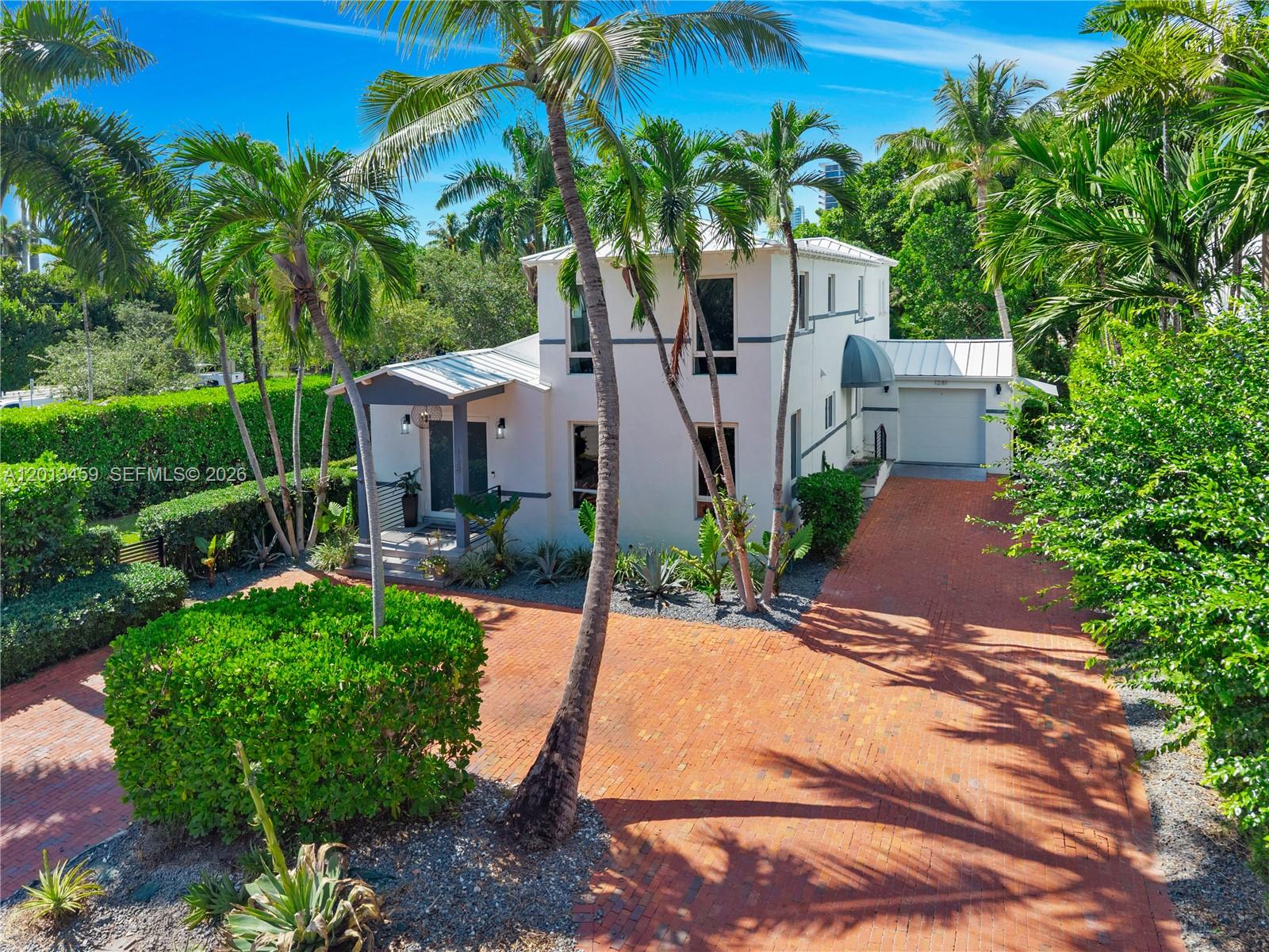 A two-story white house with a brick driveway and palm trees in the front yard — 1281 S Venetian Way, Miami FL 33139, MIAMI, FL