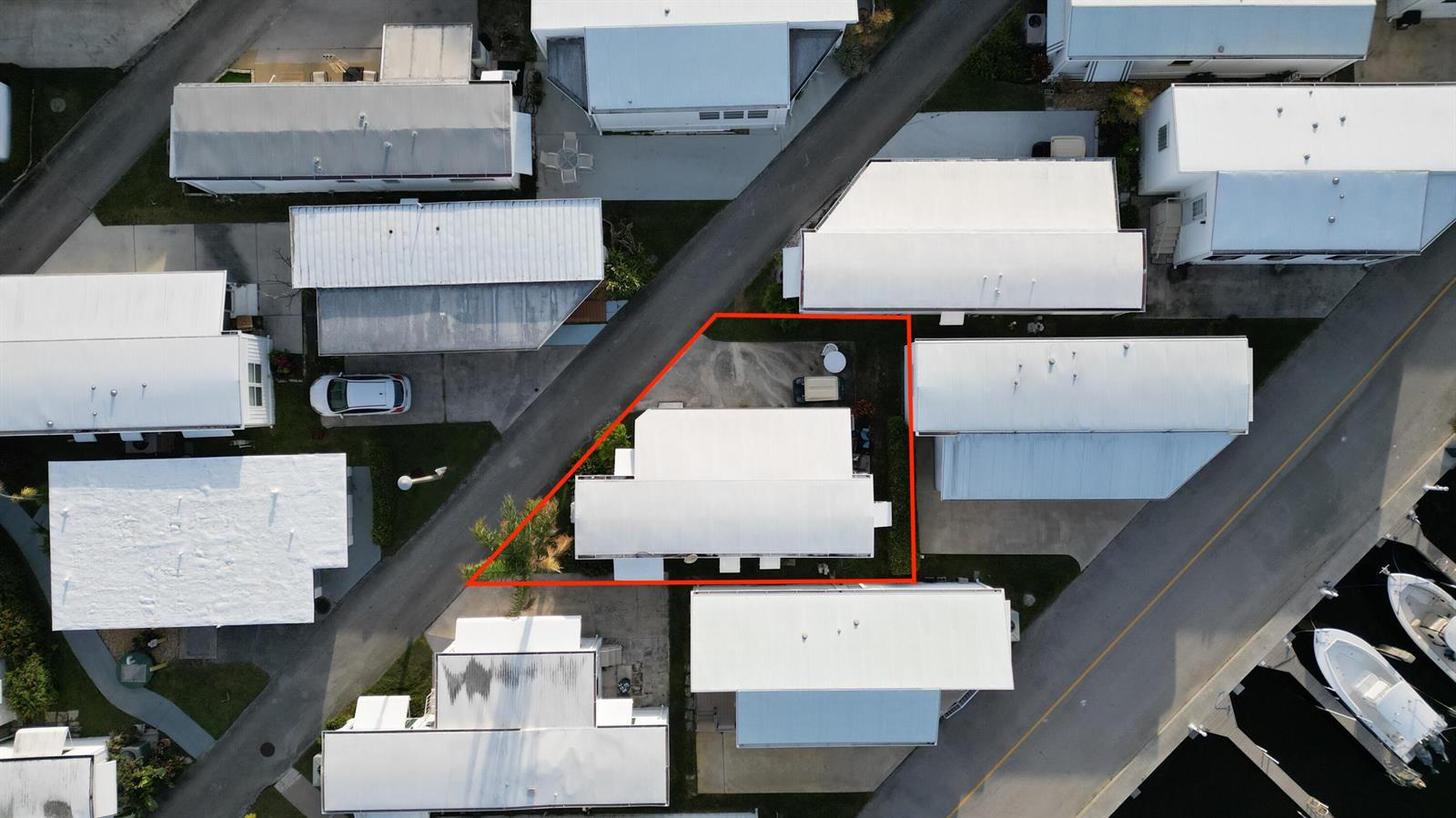 An aerial view shows a mobile home with a red outline on its property lot — 209 Eagle Drive E, Briny Breezes FL 33435, BRINY BREEZES, FL