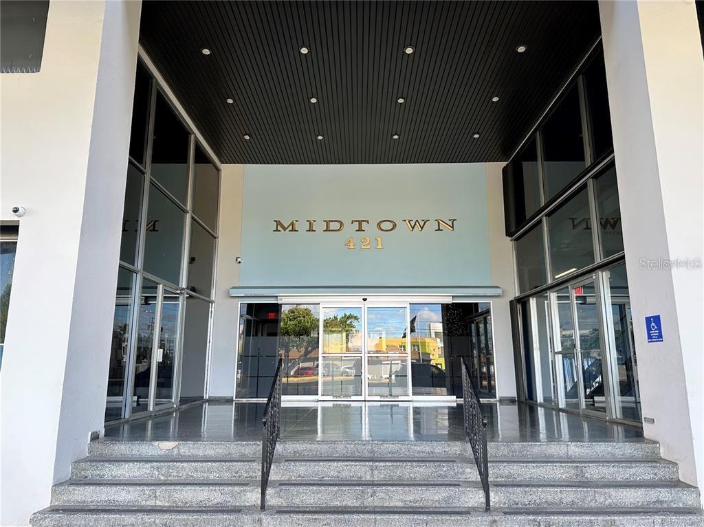 The exterior entrance of a building features a set of stairs leading to glass doors — 421 MUÑOZ RIVERA AVE, SAN JUAN, PR