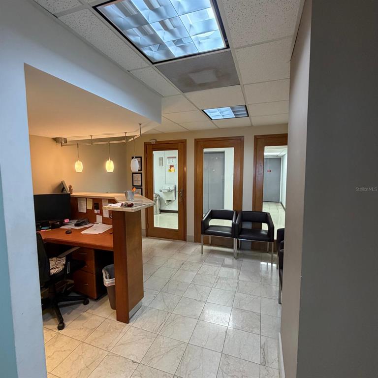 A reception area features a wooden desk, tile flooring, and three glass-paneled doors — 421 MUÑOZ RIVERA AVE, SAN JUAN, PR