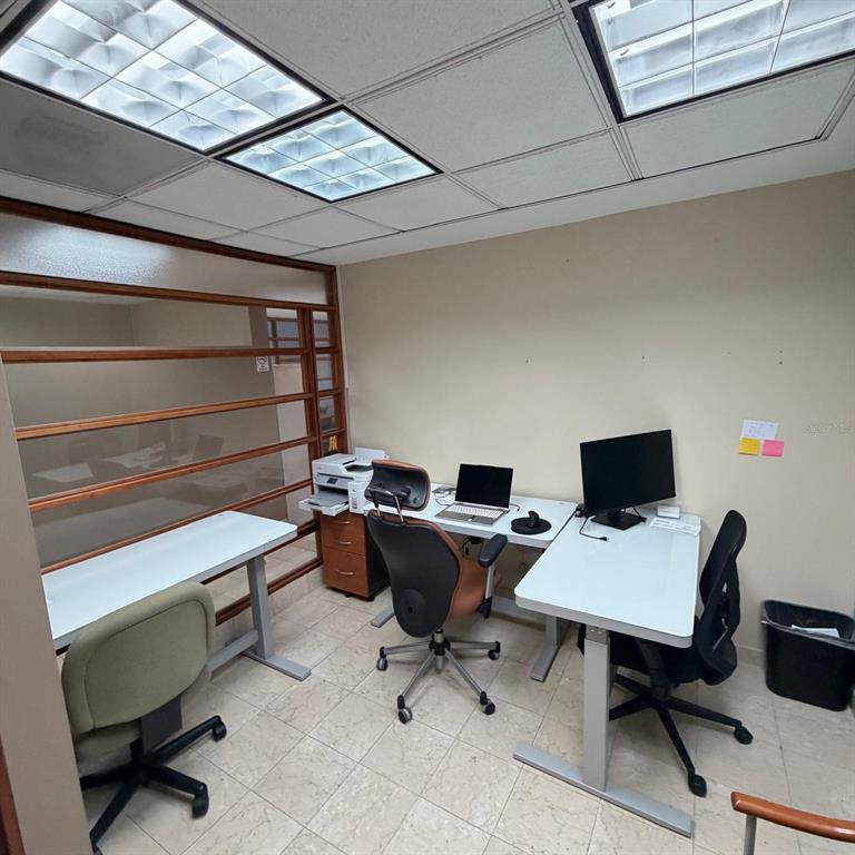 An office space with three desks, office chairs, a printer, and a glass-paneled partition wall — 421 MUÑOZ RIVERA AVE, SAN JUAN, PR