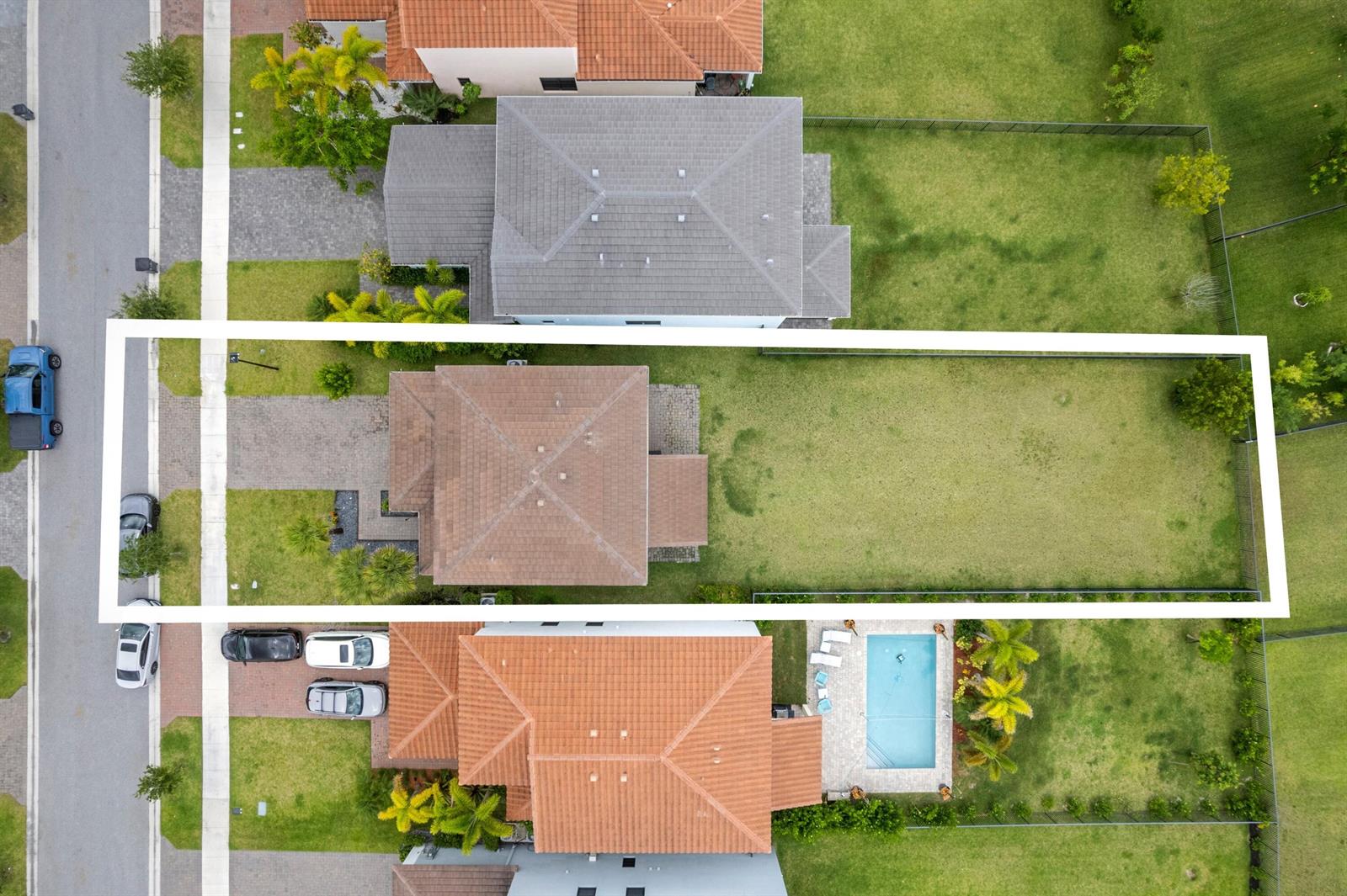 An aerial view shows a residential property with a house, driveway, and large backyard — 16169 Sea Turtle Place, Westlake FL 33470, WESTLAKE, FL