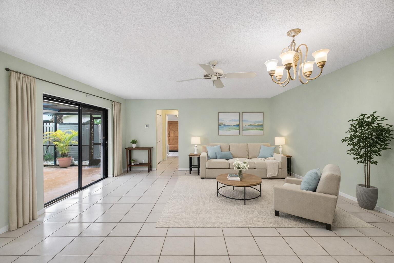 A living room with light green walls, tile flooring, a ceiling fan, and sliding glass doors — 801 NW 30th Avenue # C, Delray Beach FL 33445, DELRAY BEACH, FL