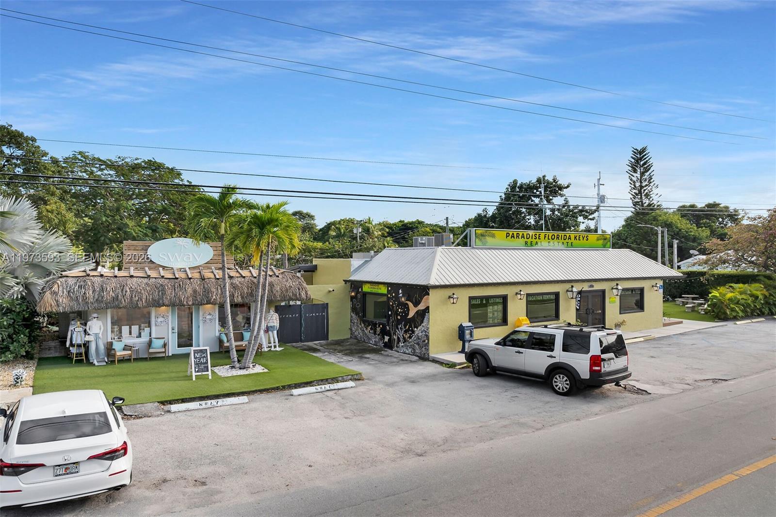 An exterior view shows two adjacent commercial buildings with a parking lot in front — 105 PALM AVE., Islamorada FL 33036, ISLAMORADA, FL