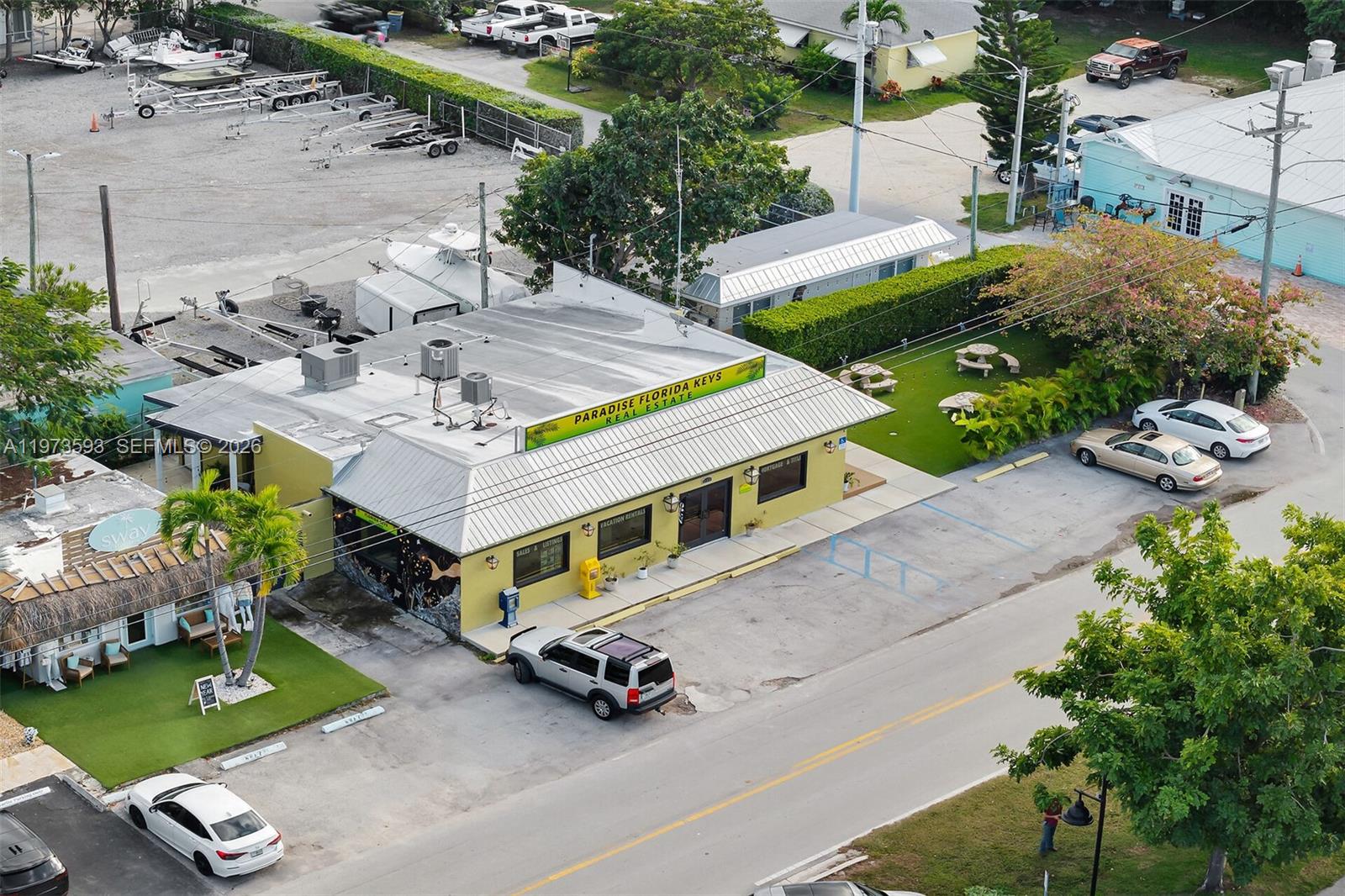 An aerial view shows a yellow commercial building with a metal roof and parking lot — 105 PALM AVE., Islamorada FL 33036, ISLAMORADA, FL