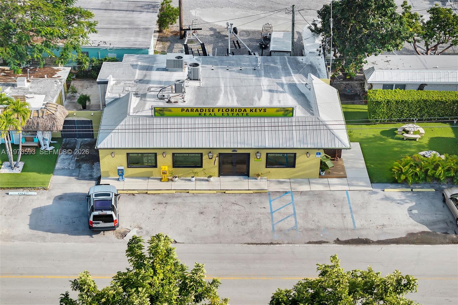 An aerial view shows a yellow commercial building with a metal roof and parking lot — 105 PALM AVE., Islamorada FL 33036, ISLAMORADA, FL