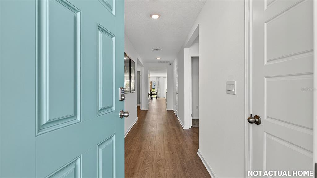This is a digital rendering of an entryway looking down a hallway with wood-look flooring — 69 RYBERRY DRIVE, PALM COAST, FL