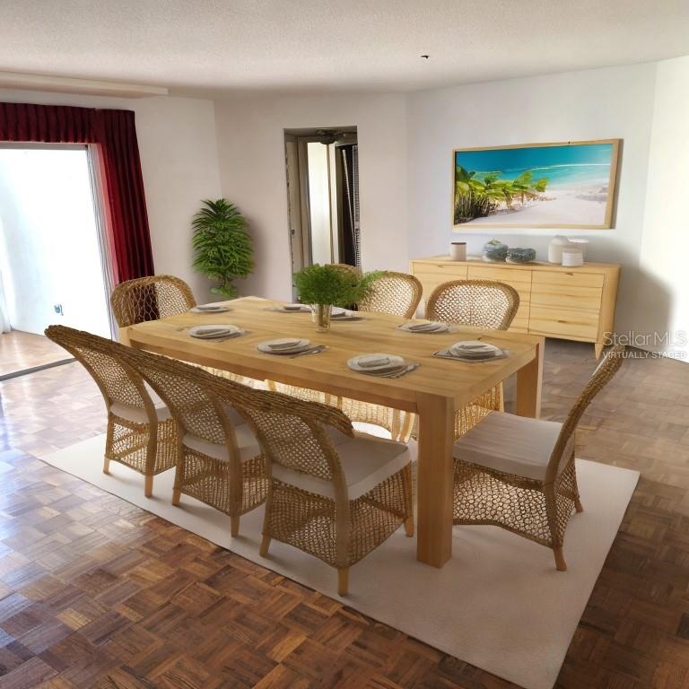 This virtually staged dining room features a wooden table, wicker chairs, and parquet flooring — 435 S GULFSTREAM AVENUE UNIT 605, SARASOTA, FL