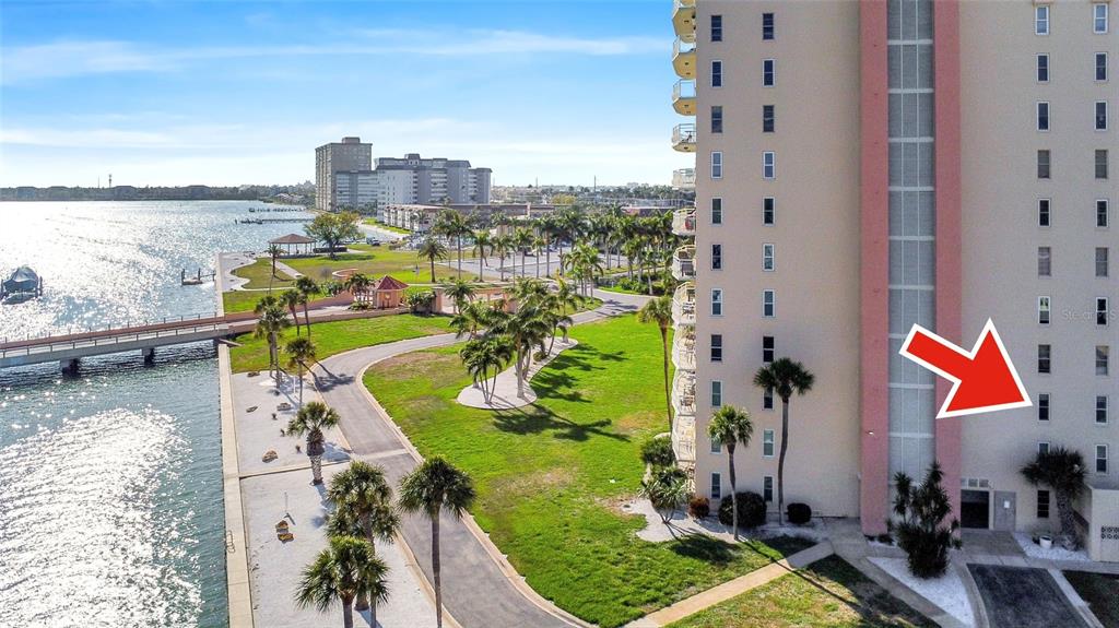An exterior view of a high-rise building with a red arrow pointing to a window — 4900 BRITTANY DRIVE S UNIT 301, ST PETERSBURG, FL