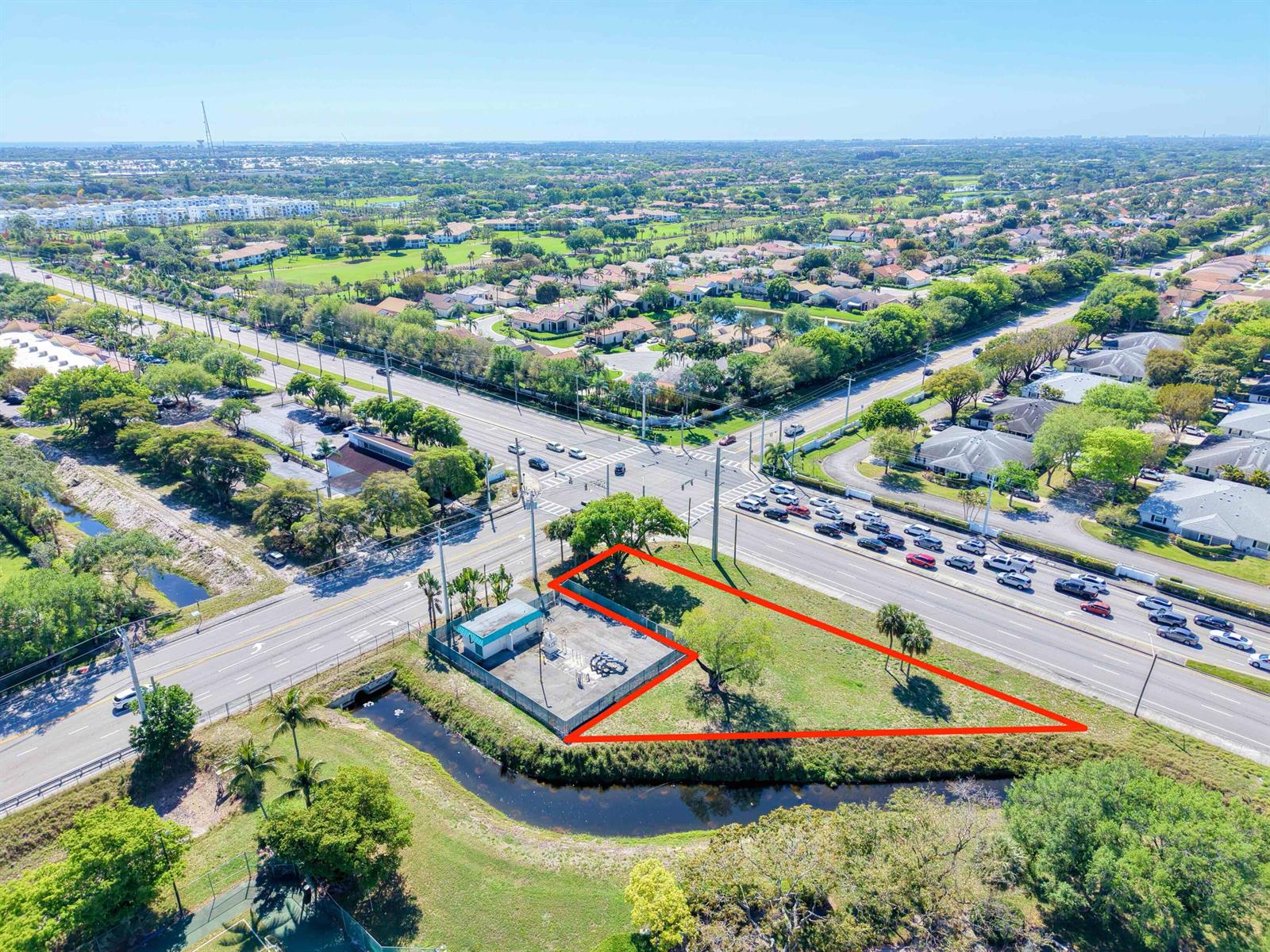 An aerial view shows a triangular, fenced lot with a utility building at a road intersection — Xxxx Lawrence Road, Boynton Beach FL 33436, BOYNTON BEACH, FL