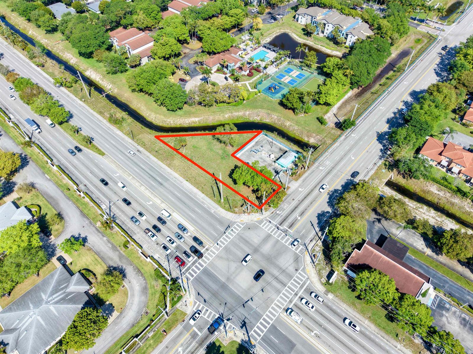 An aerial view shows a vacant triangular lot situated at a busy road intersection — Xxxx Lawrence Road, Boynton Beach FL 33436, BOYNTON BEACH, FL