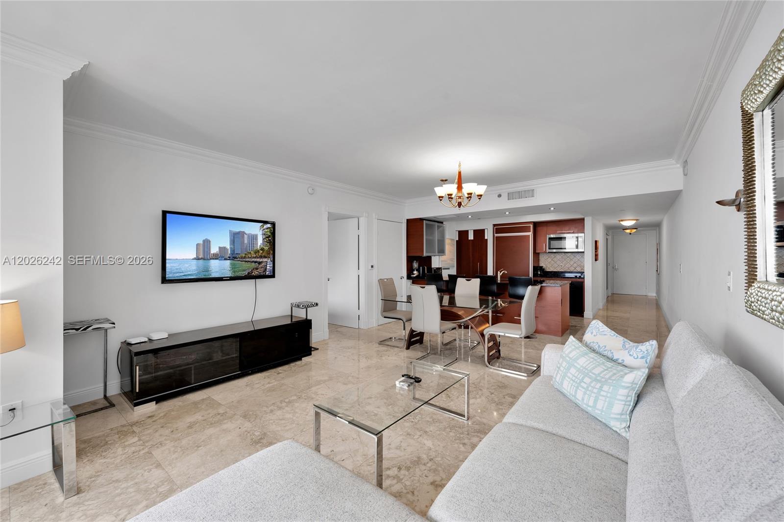 A living room and dining area feature marble floors, a glass table, and a kitchen — 1830 S OCEAN DR # 3310, Hallandale Beach FL 33009, HALLANDALE BEACH, FL