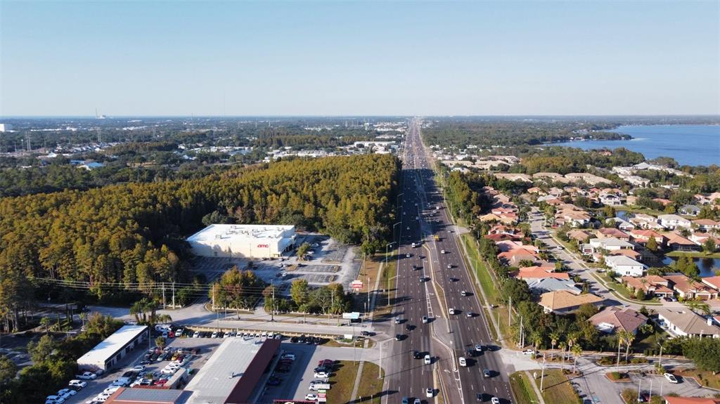 An aerial view shows a multi-lane road, a movie theater, and surrounding residential neighborhoods — 37548 US HWY 19 N, PALM HARBOR, FL