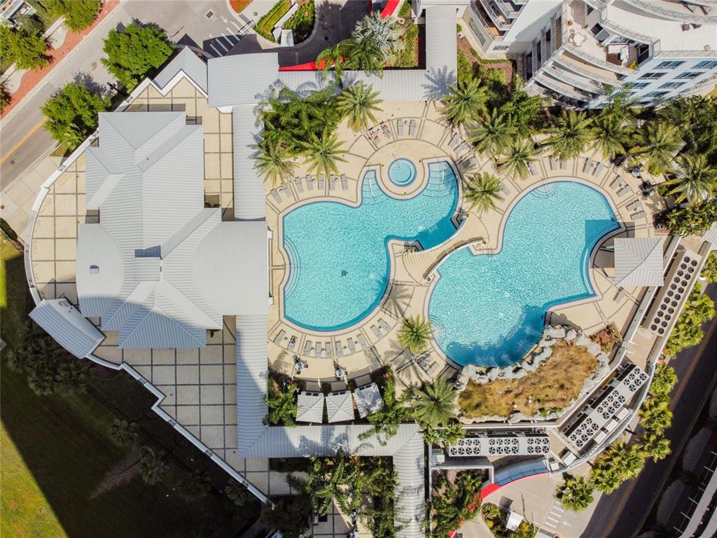 An aerial view shows a large building with a metal roof and two connected swimming pools — 449 S 12TH STREET UNIT 1406, TAMPA, FL