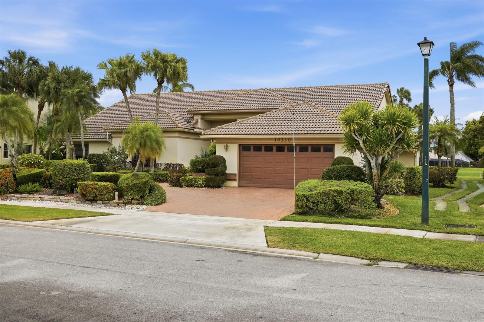 A single-story house with a brown tile roof, a two-car garage, and landscaped front yard — 10330 Silver Lake Drive, Boca Raton FL 33428, BOCA RATON, FL