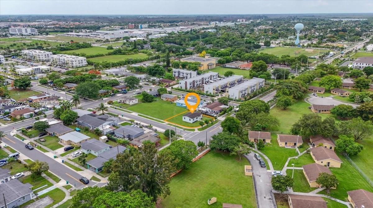 An aerial view shows a single-story house on a corner lot in a suburban neighborhood — 813 NW 6th Ave, Florida City FL 33034, FLORIDA CITY, FL