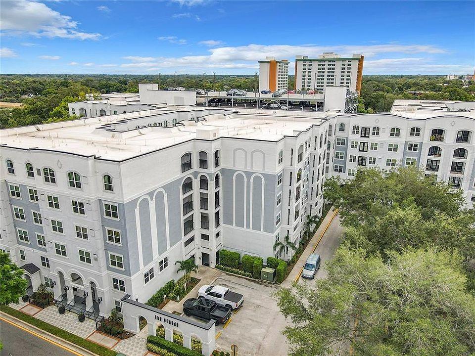An aerial view shows a multi-story apartment complex with an attached parking garage — 204 E SOUTH STREET UNIT 3059, ORLANDO, FL