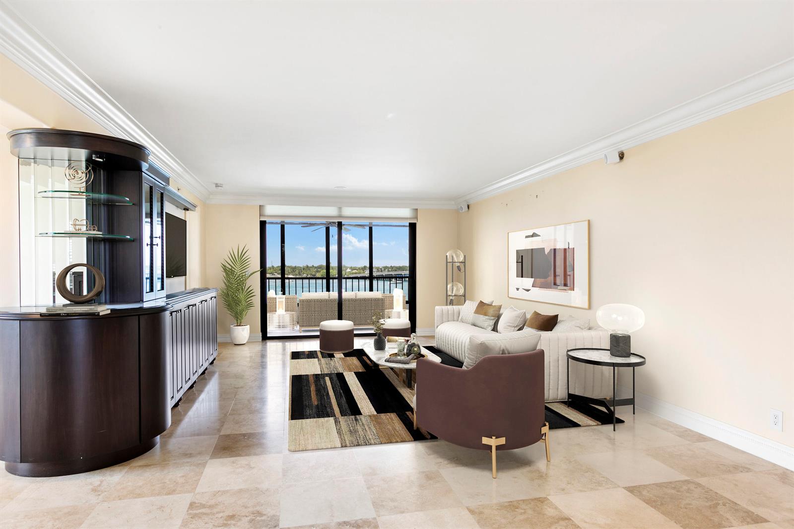 A living room features a dark wood cabinet, a patterned rug, and a balcony overlooking water — 1748 Jupiter Cove Drive # 524a, Jupiter FL 33469, JUPITER, FL