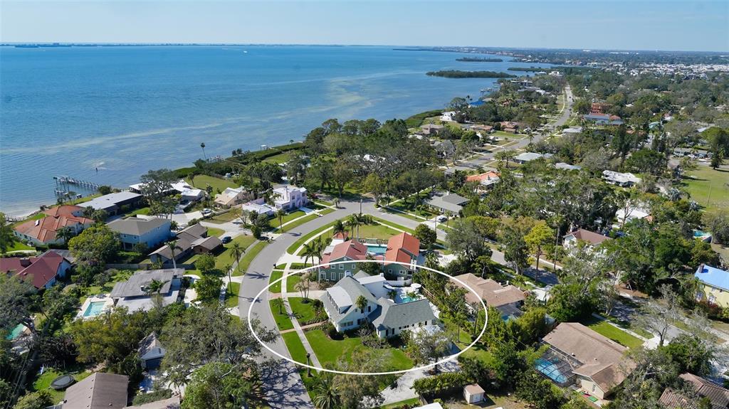 An aerial view shows a residential house with a pool in a coastal neighborhood — 7715 WESTMORELAND DRIVE, SARASOTA, FL