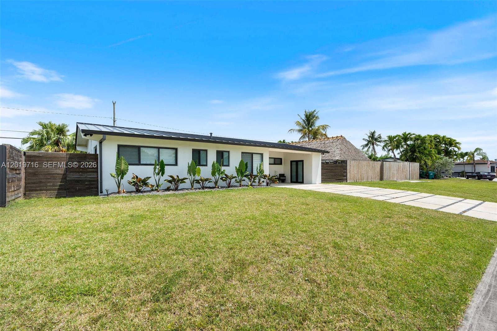 A single-story white house with a metal roof and a large front lawn — 9460 Haitian Dr, Cutler Bay FL 33189, CUTLER BAY, FL