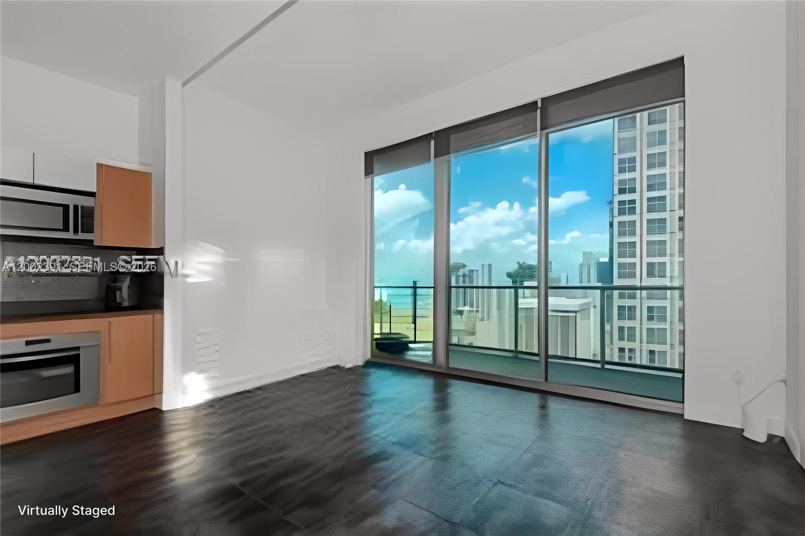 This room features dark flooring, a small kitchen area, and floor-to-ceiling windows with balcony access — 300 S Biscayne Blvd # 3903, Miami FL 33131, MIAMI, FL