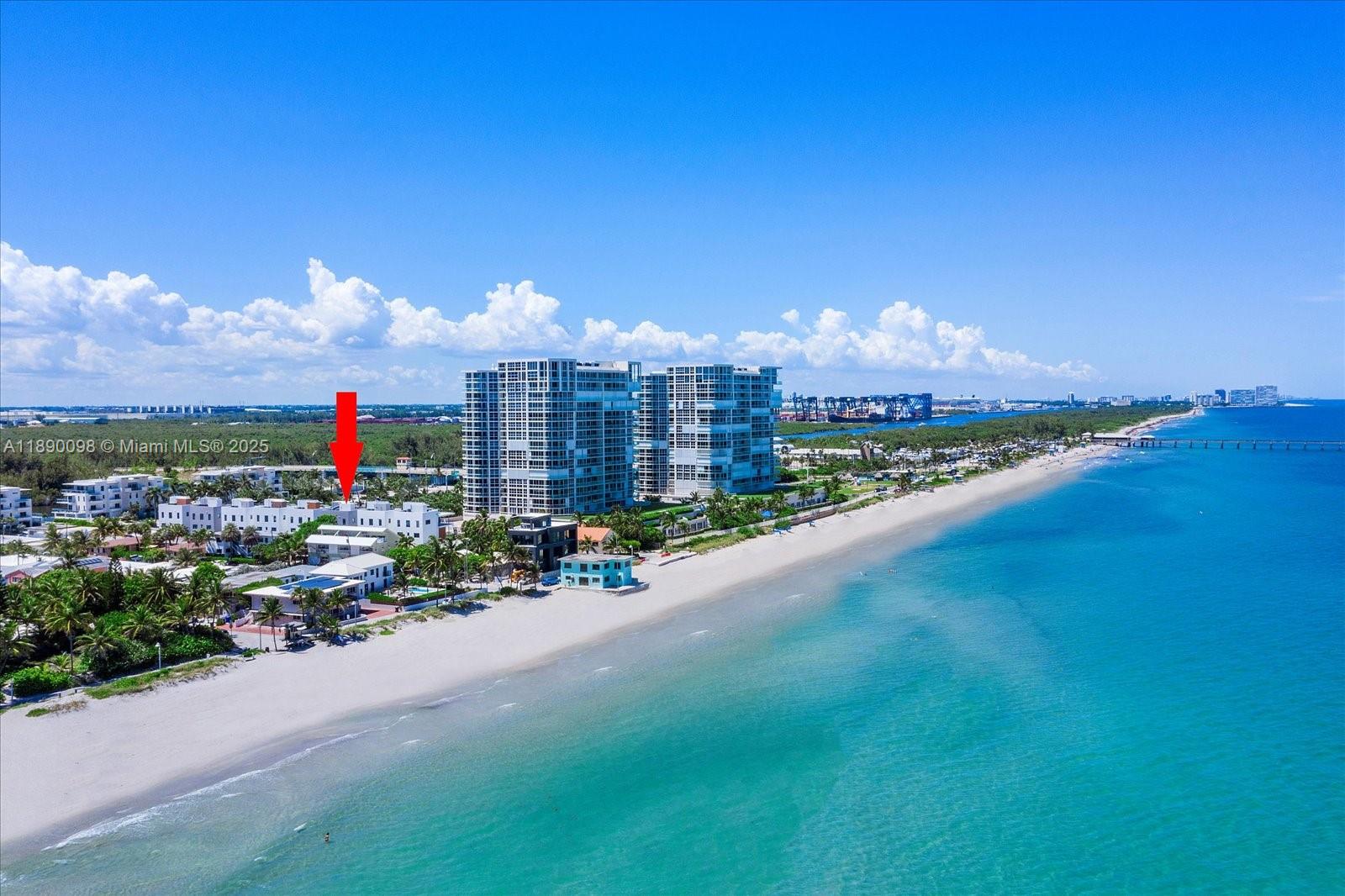 An aerial view shows a beach, ocean, and a multi-story building marked with a red arrow — 332 Balboa St, Hollywood FL 33019, HOLLYWOOD, FL
