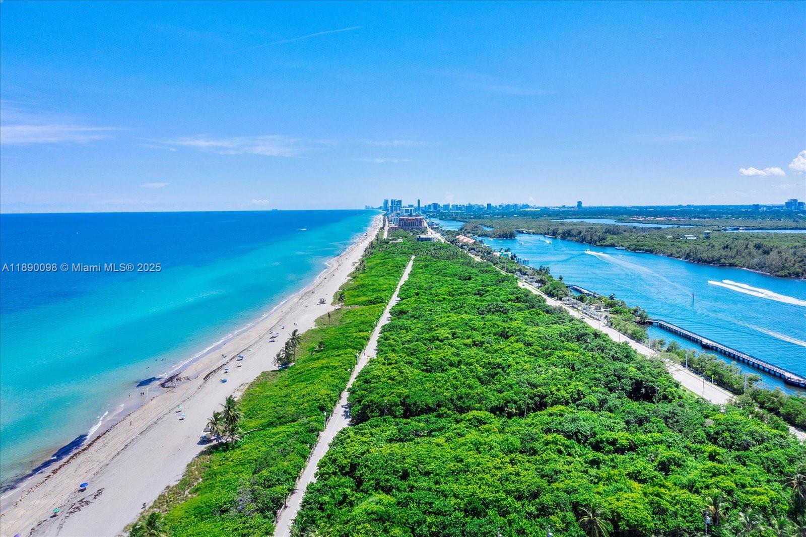 An aerial view shows a sandy beach, dense green vegetation, and a waterway with boats — 332 Balboa St, Hollywood FL 33019, HOLLYWOOD, FL