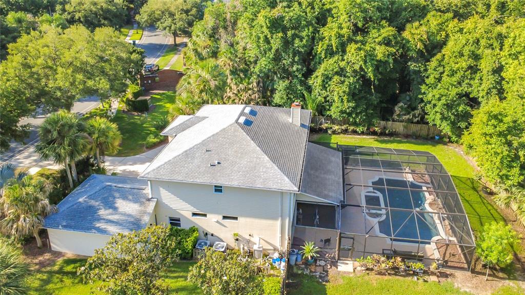 An aerial view of a two-story house with a pool enclosed by a screen cage — 1838 SENECA BLVD, WINTER SPRINGS, FL