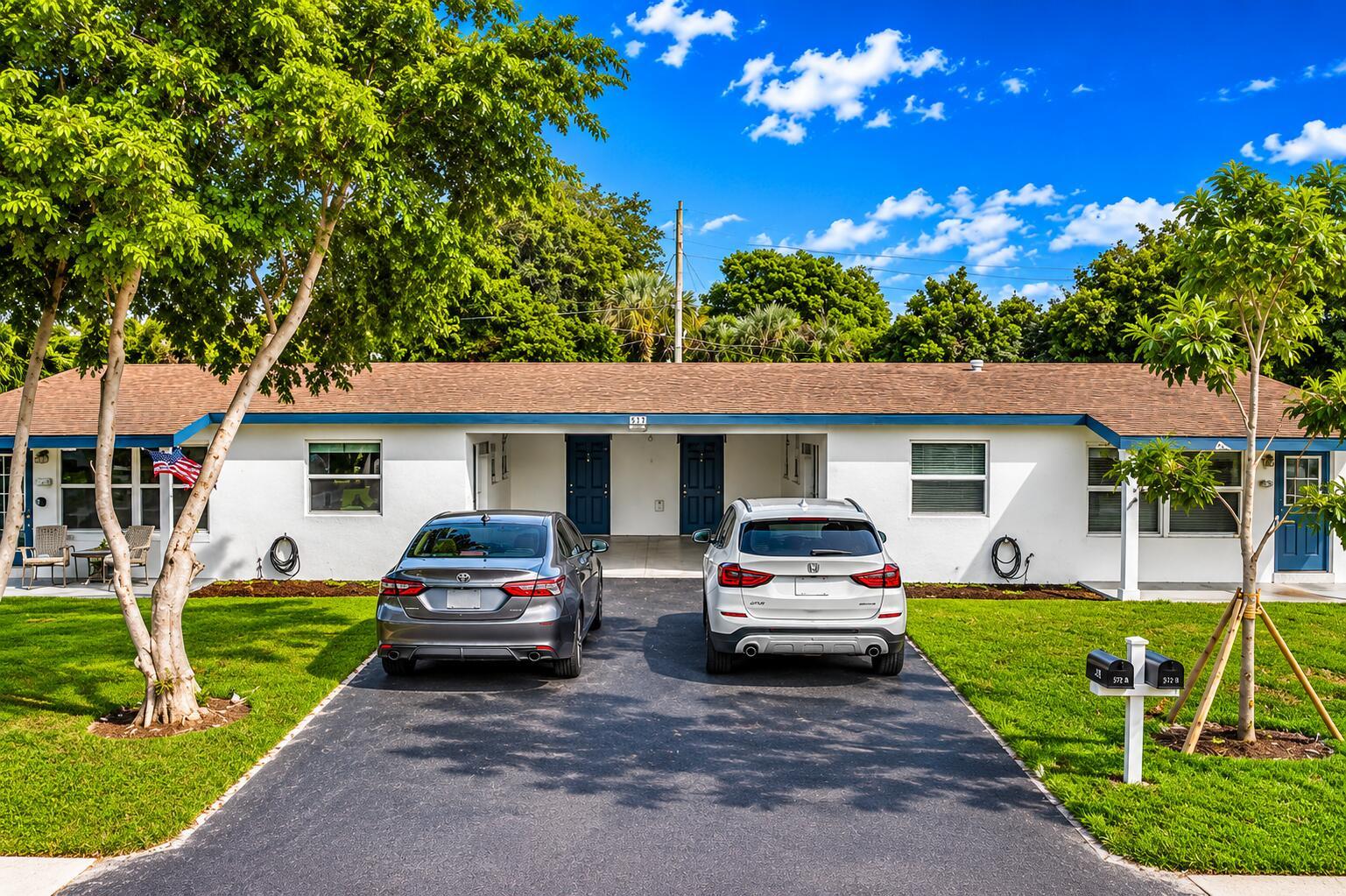 A single-story white duplex with a brown roof and two cars parked in the driveway — 508 NE 12th Avenue, Pompano Beach FL 33060, POMPANO BEACH, FL