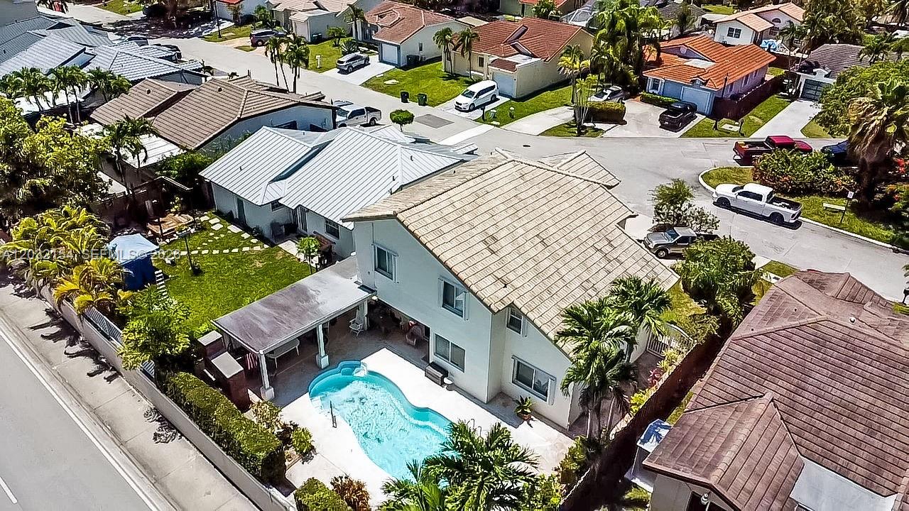 An aerial view shows a two-story house with a backyard pool and covered patio — 8532 SW 211th Ter, Cutler Bay FL 33189, CUTLER BAY, FL