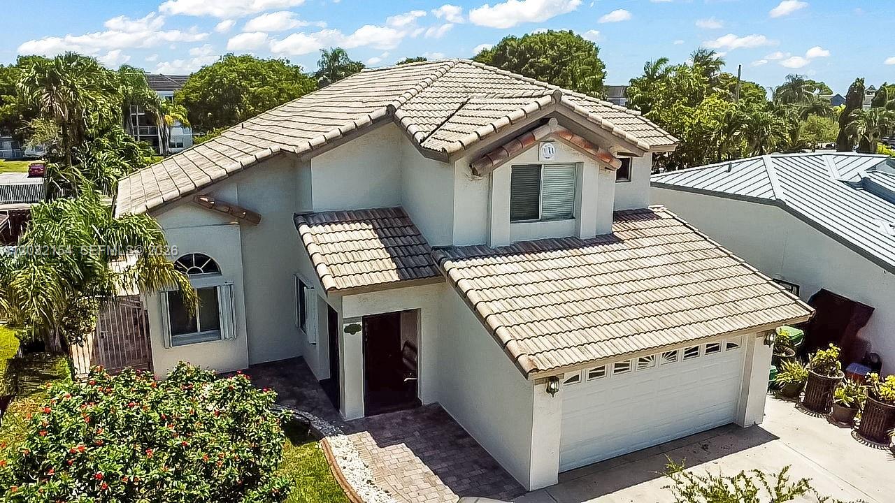 An aerial view of a two-story house with a tiled roof and a front garage — 8532 SW 211th Ter, Cutler Bay FL 33189, CUTLER BAY, FL