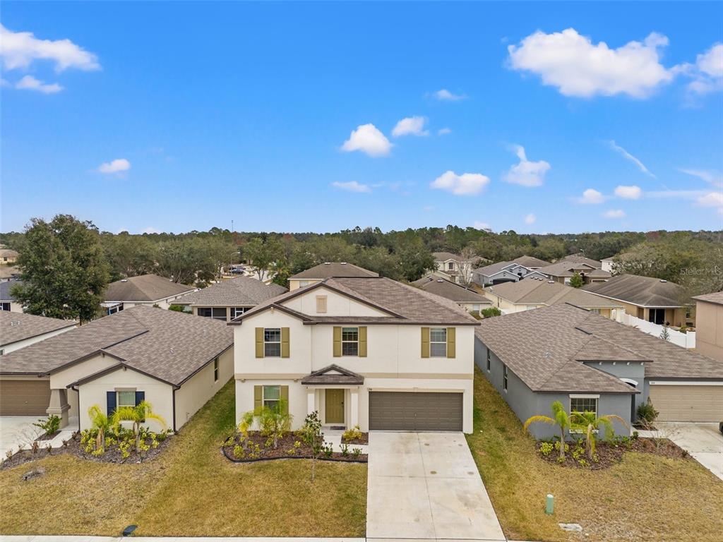 An aerial view of a two-story suburban house with a concrete driveway and landscaped yard — 194 ARGYLL DRIVE, SPRING HILL, FL