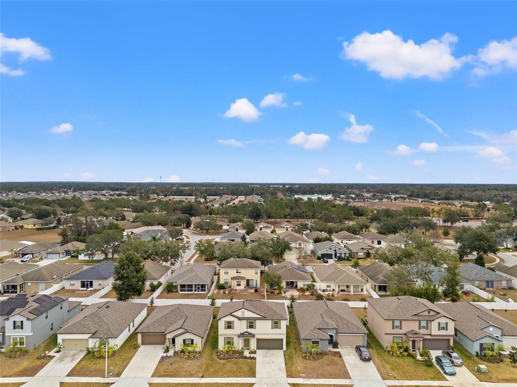 An aerial view shows a suburban neighborhood with single-family homes and paved streets — 194 ARGYLL DRIVE, SPRING HILL, FL