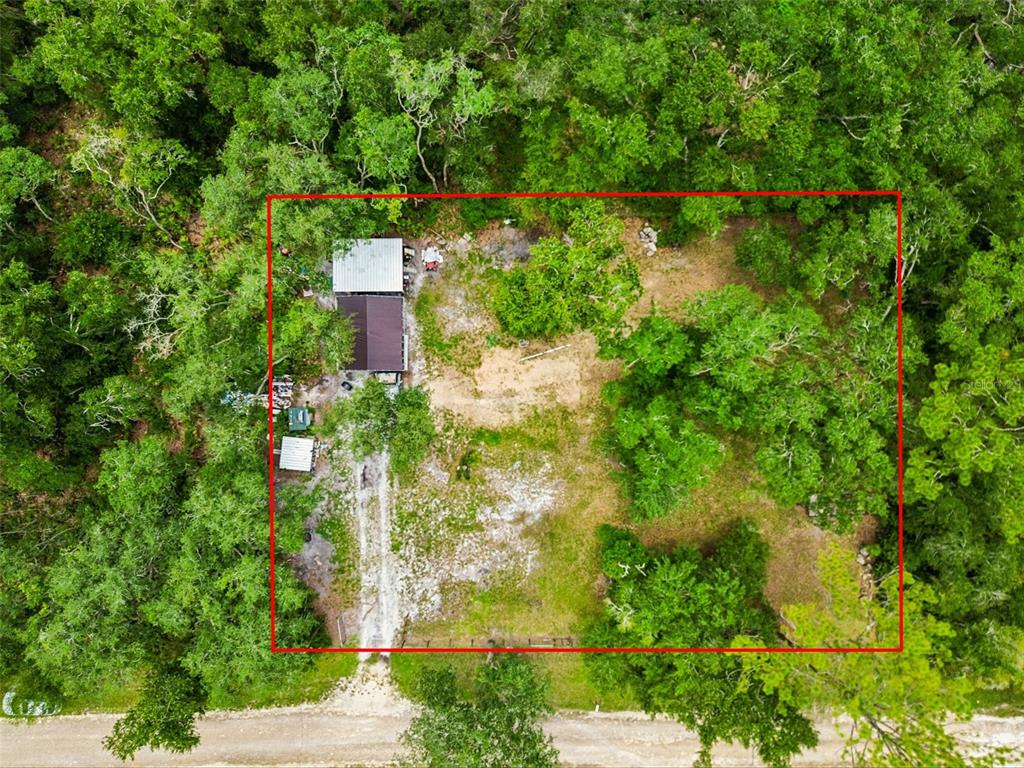 An aerial view shows a small house and outbuildings on a wooded, rectangular lot — 35314 GOETHALS STREET, WEBSTER, FL
