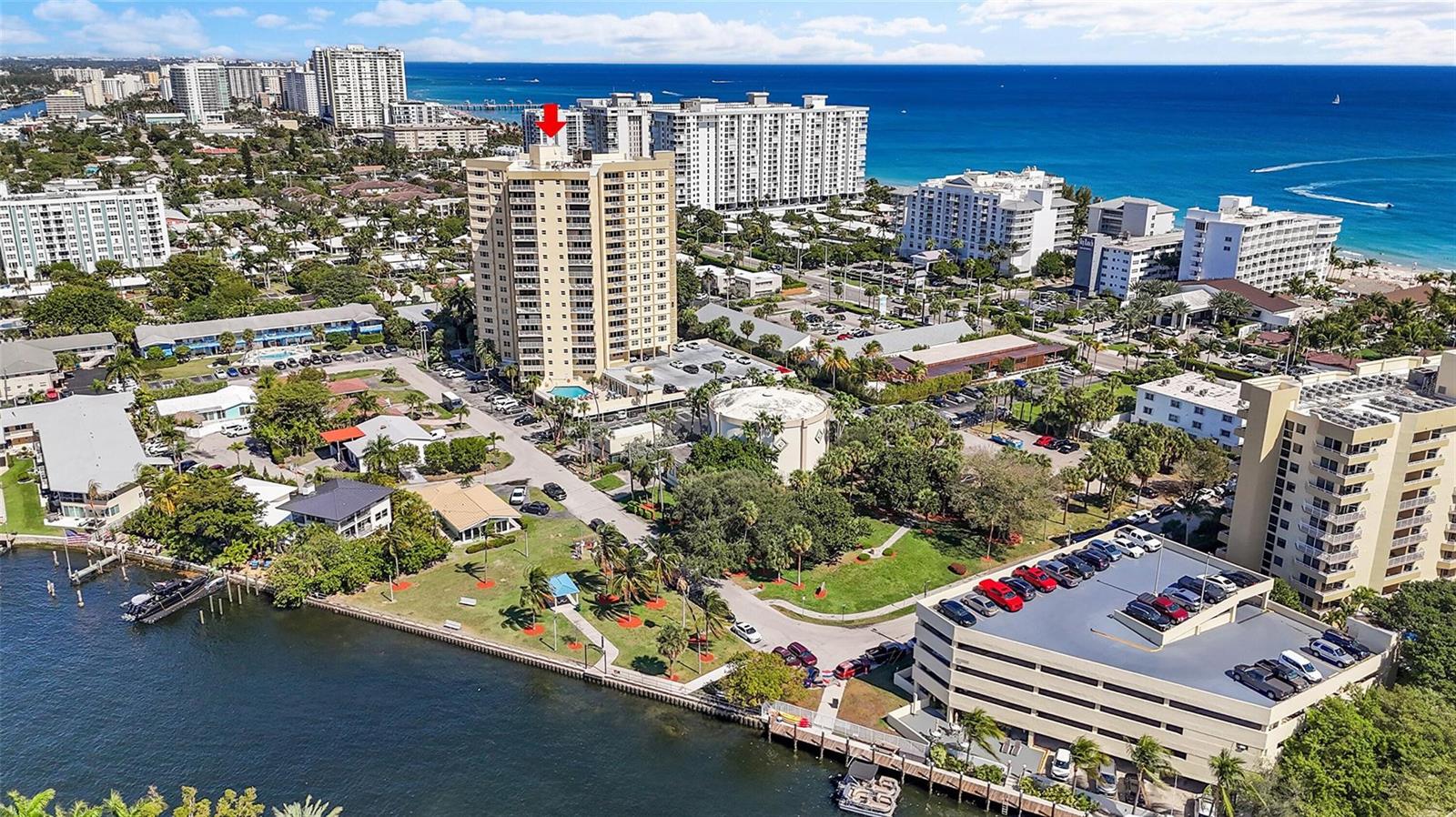 An aerial view shows a high-rise residential building near a waterfront park and parking garage — 1200 Hibiscus Avenue, Pompano Beach FL 33062, POMPANO BEACH, FL