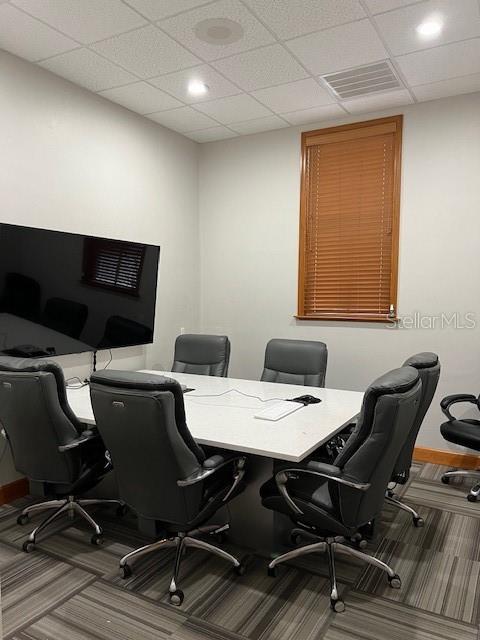 A conference room features a white table, six black office chairs, and a wall-mounted television — 4965 SW 91ST TERRACE UNIT A, GAINESVILLE, FL