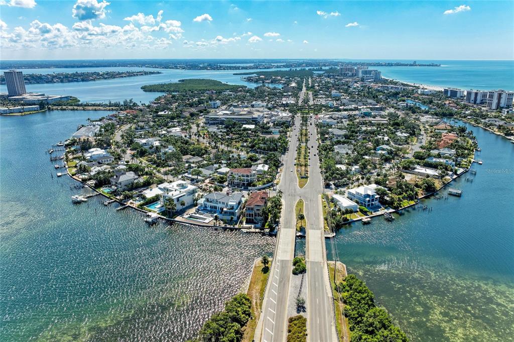 An aerial view of a coastal neighborhood featuring a bridge leading into a residential area — 244 N WASHINGTON DRIVE, SARASOTA, FL