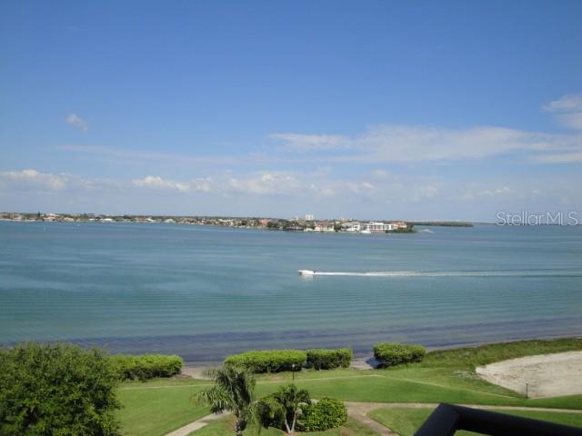 A high-angle view of a calm bay with a small boat and distant shoreline — 6158 PALMA DEL MAR BOULEVARD S UNIT 401, ST PETERSBURG, FL