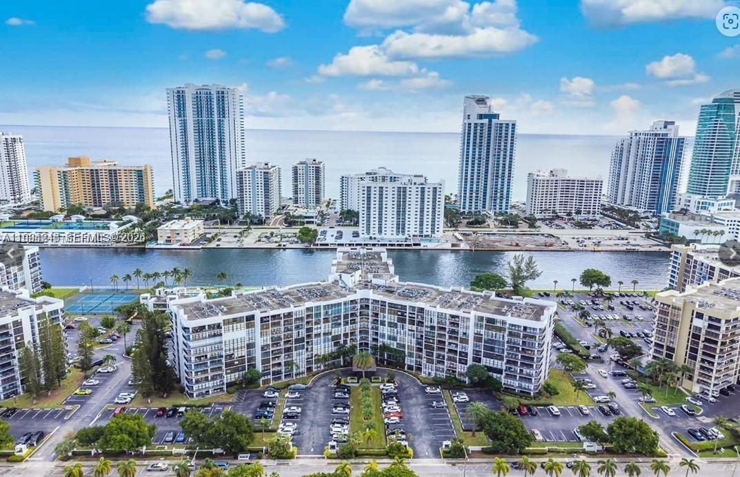 An aerial view of a waterfront residential complex with high-rise buildings in the background — 800 Parkview Dr # 527, Hallandale Beach FL 33009, HALLANDALE BEACH, FL