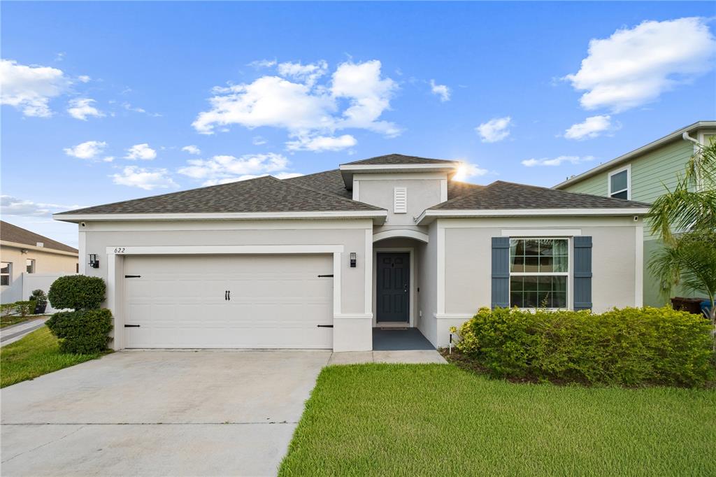 A single-story house with a two-car garage, gray exterior, and a front-facing entrance — 622 TAFT DRIVE, DAVENPORT, FL