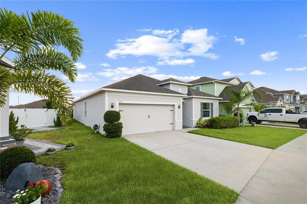 A single-story suburban house with a two-car garage and a concrete driveway — 622 TAFT DRIVE, DAVENPORT, FL