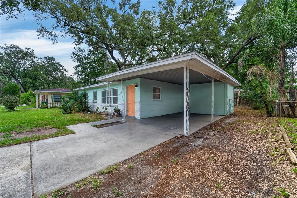 A light green single-story house with a flat roof and an attached carport — 3009 E FERN STREET, TAMPA, FL