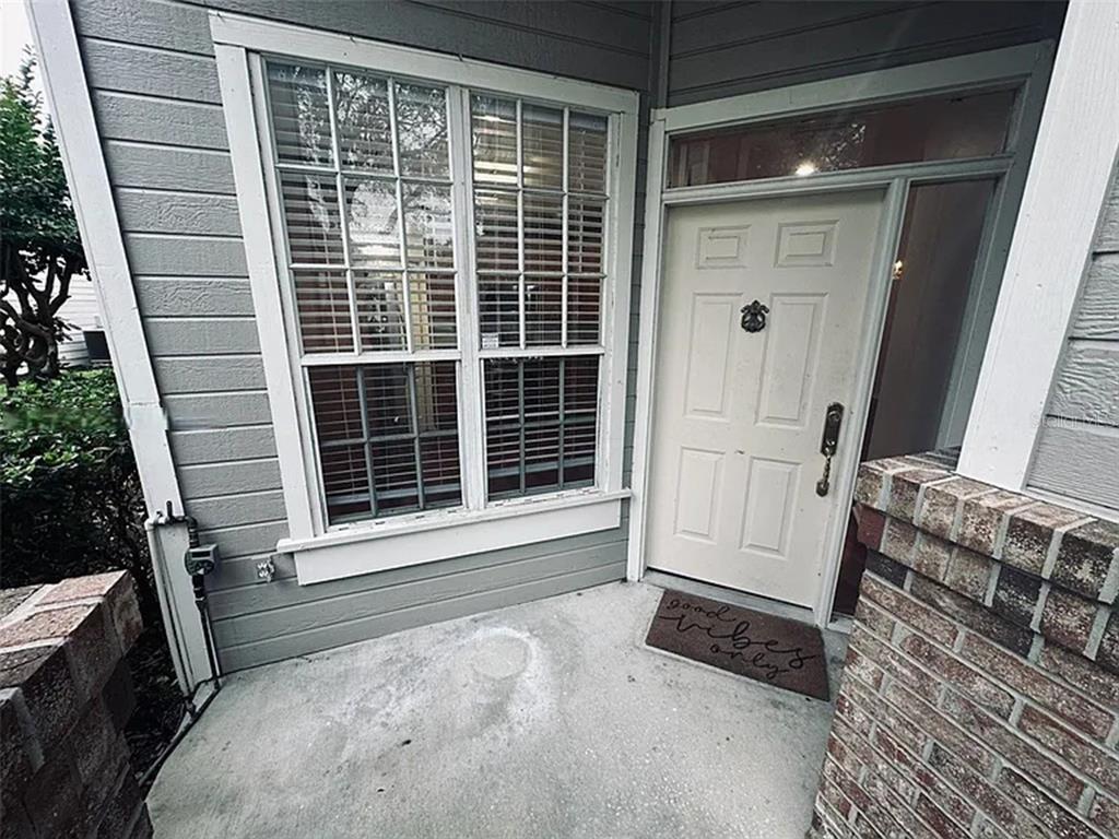A front porch features a white door, a large window, and a brick pillar — 3125 STONEWATER DRIVE, LAKELAND, FL