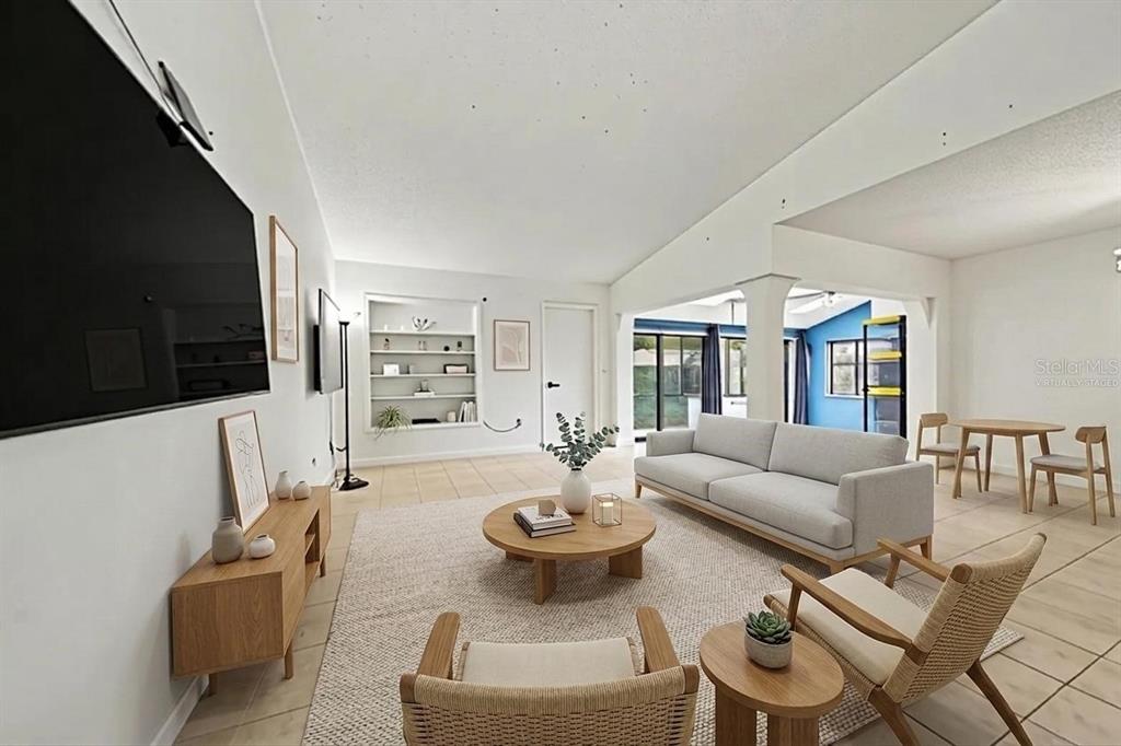 A living room features a floating wooden console, two wall-mounted televisions, and a built-in shelf — 2008 HOUNDSLAKE DRIVE, WINTER PARK, FL