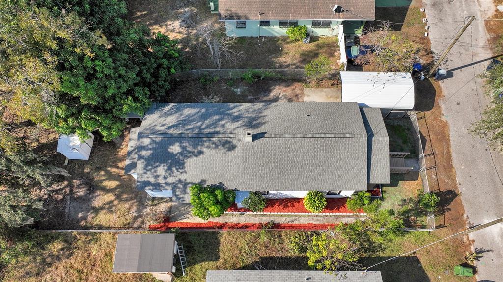 An aerial view shows a house with a gray shingled roof and a white carport — 3203 E 38TH AVENUE, TAMPA, FL