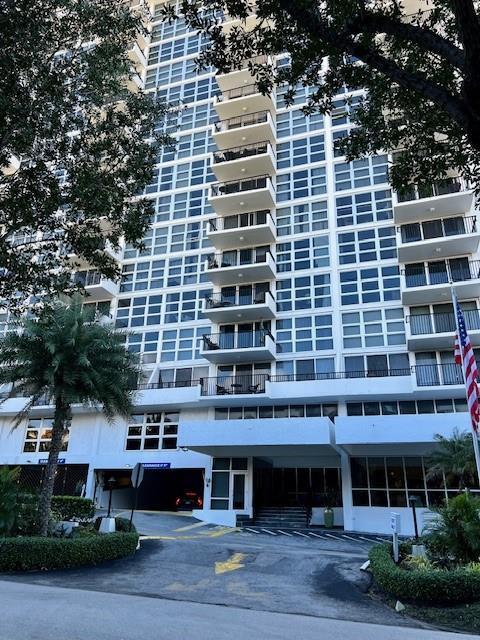 A tall white residential high-rise building features stacked balconies and a ground-level parking entrance — 531 N Ocean Boulevard # 1808, Pompano Beach FL 33062, POMPANO BEACH, FL